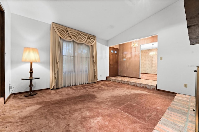 spare room with vaulted ceiling and carpet