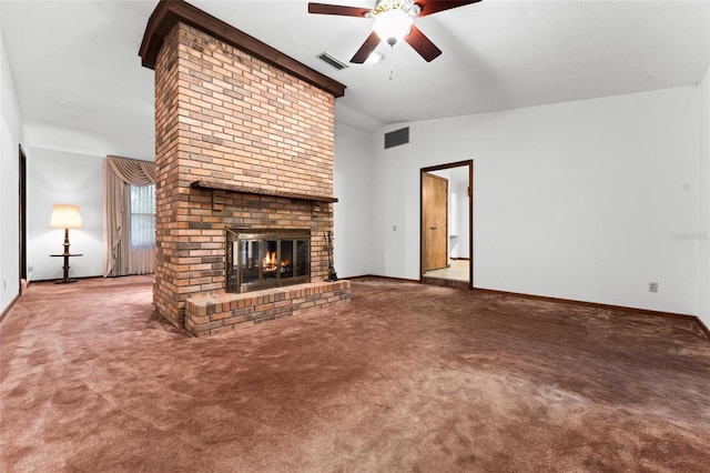 unfurnished living room featuring lofted ceiling, ceiling fan, a fireplace, and carpet floors