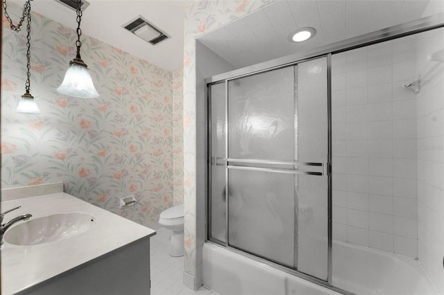 full bathroom featuring shower / bath combination with glass door, tile patterned flooring, toilet, and vanity