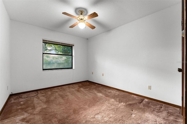 empty room with ceiling fan and carpet flooring