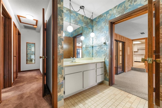 bathroom featuring a textured ceiling and vanity