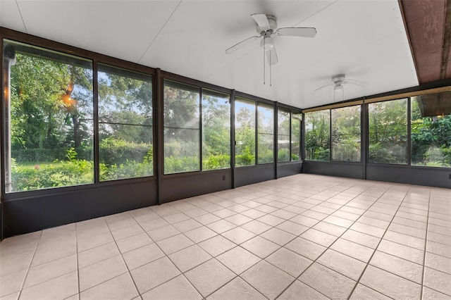 unfurnished sunroom featuring ceiling fan