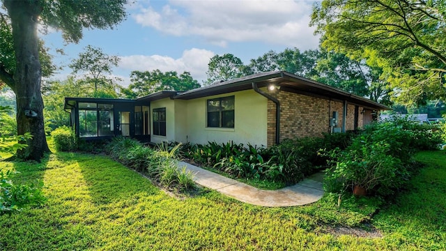 view of side of home featuring a lawn