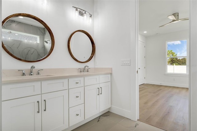 bathroom with a shower, vanity, hardwood / wood-style floors, and ceiling fan