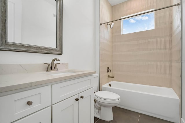 full bathroom featuring vanity, tile patterned floors, toilet, and tiled shower / bath combo