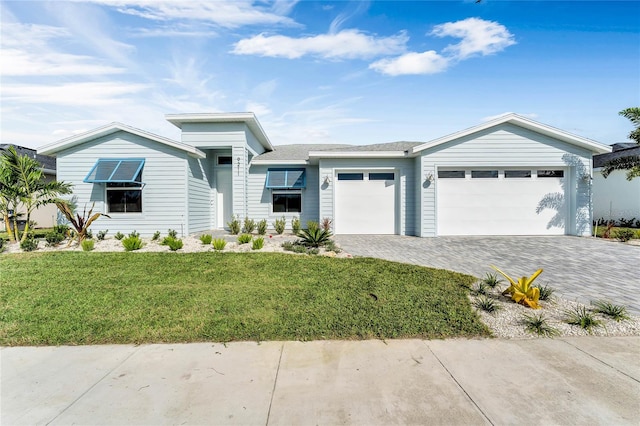 view of front facade with a garage and a front lawn