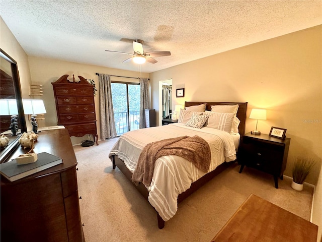 bedroom featuring carpet flooring, ceiling fan, and a textured ceiling