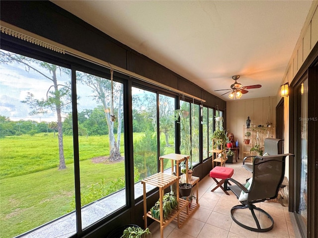 sunroom / solarium featuring ceiling fan