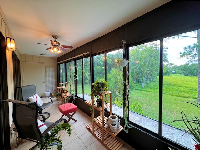 sunroom featuring ceiling fan