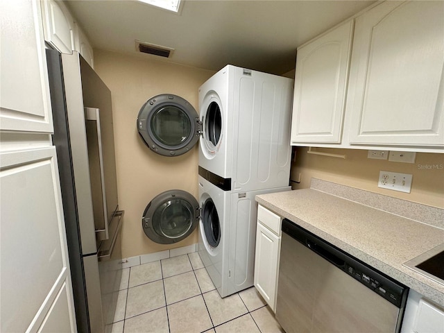 laundry room with light tile patterned floors and stacked washer and clothes dryer