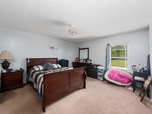 carpeted bedroom featuring a textured ceiling and ceiling fan