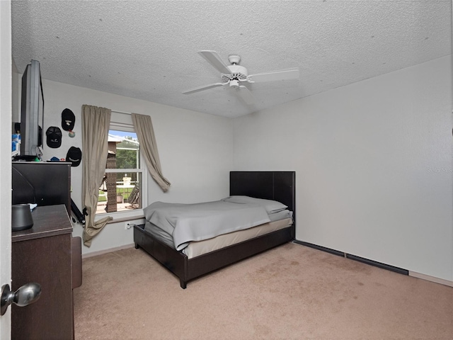 carpeted bedroom with a textured ceiling and ceiling fan