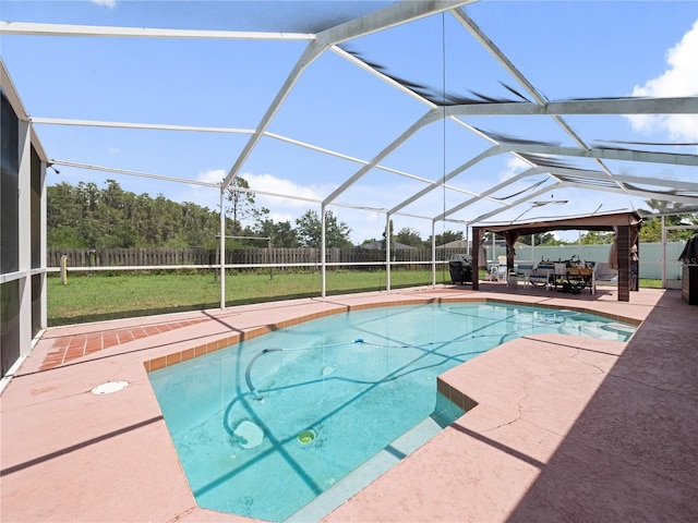 view of swimming pool featuring glass enclosure, a lawn, and a patio