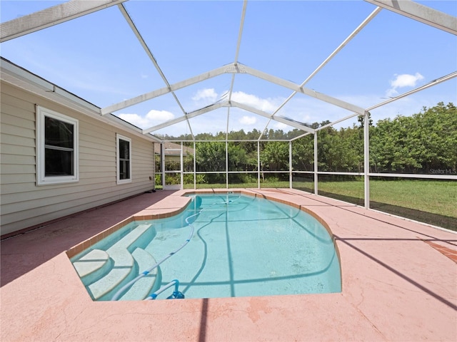 view of swimming pool featuring a lanai, a lawn, and a patio