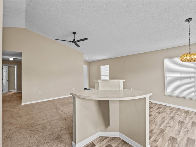 2977 Kokomo Loop, Haines City, FL 33844 - unfurnished room with vaulted ceiling, a ceiling fan, a textured ceiling, and light wood finished floors