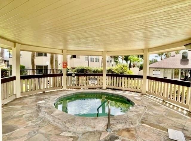 view of swimming pool with an indoor hot tub