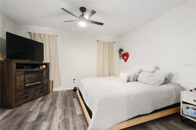 bedroom with wood-type flooring and ceiling fan