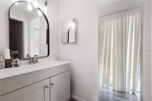 bathroom with vanity and wood-type flooring