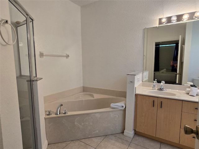 bathroom featuring tile patterned flooring, vanity, and plus walk in shower