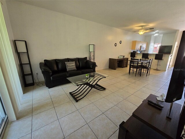 living room with ceiling fan and light tile patterned floors