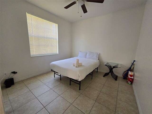 bedroom featuring light tile patterned flooring and ceiling fan