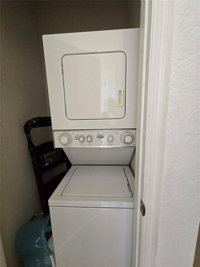 washroom with stacked washer and dryer