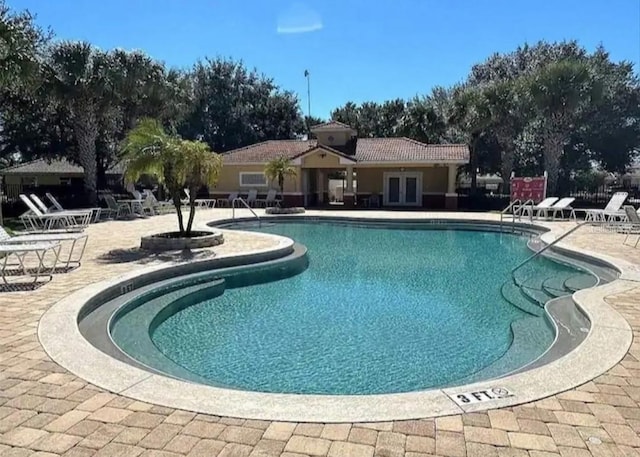 pool featuring french doors and a patio area