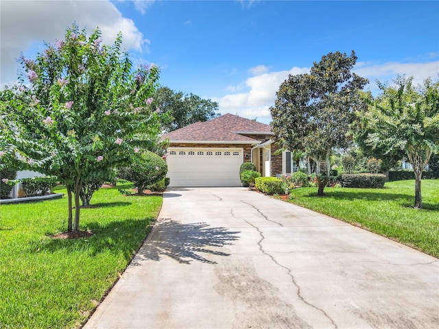 view of front of property featuring a garage and a front lawn