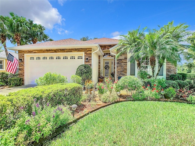 view of front of house featuring a garage and a front lawn