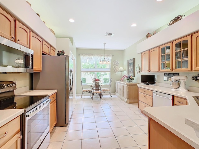 kitchen with light tile patterned floors, an inviting chandelier, decorative light fixtures, and appliances with stainless steel finishes