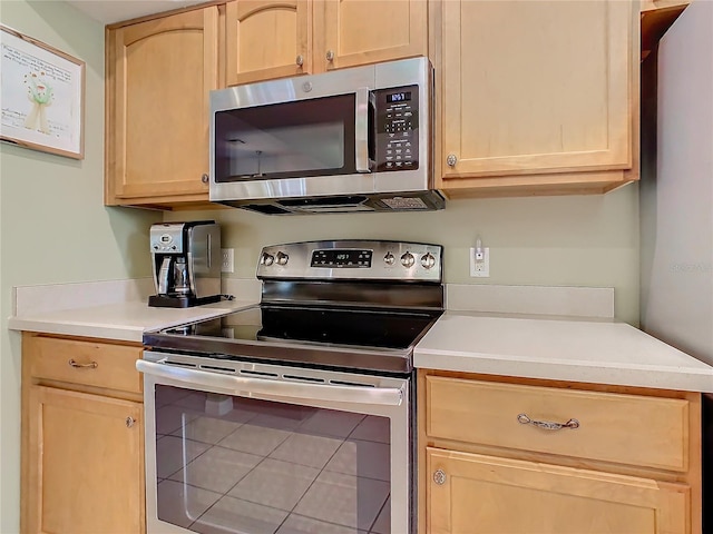 kitchen featuring appliances with stainless steel finishes and light brown cabinets