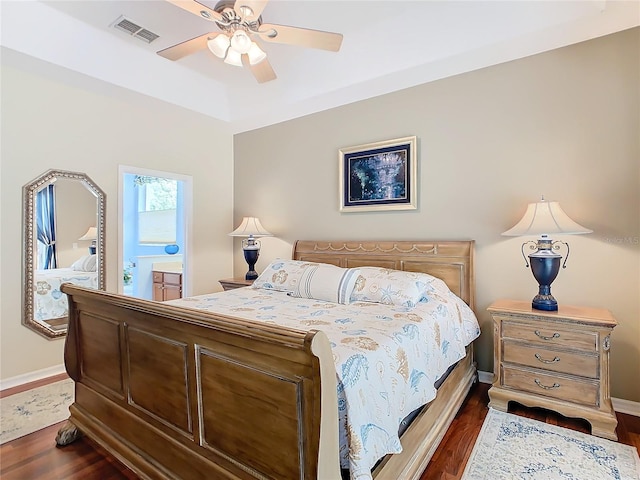 bedroom with ensuite bath, dark hardwood / wood-style flooring, and ceiling fan