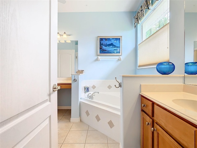 bathroom with tile patterned flooring, vanity, and a relaxing tiled tub