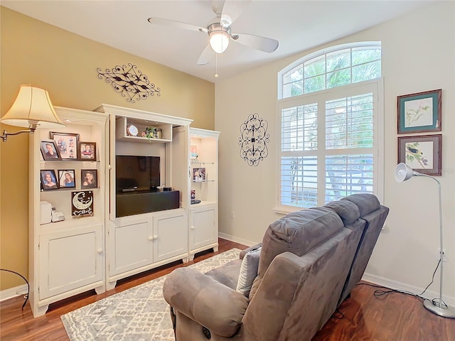 living room featuring ceiling fan and hardwood / wood-style floors