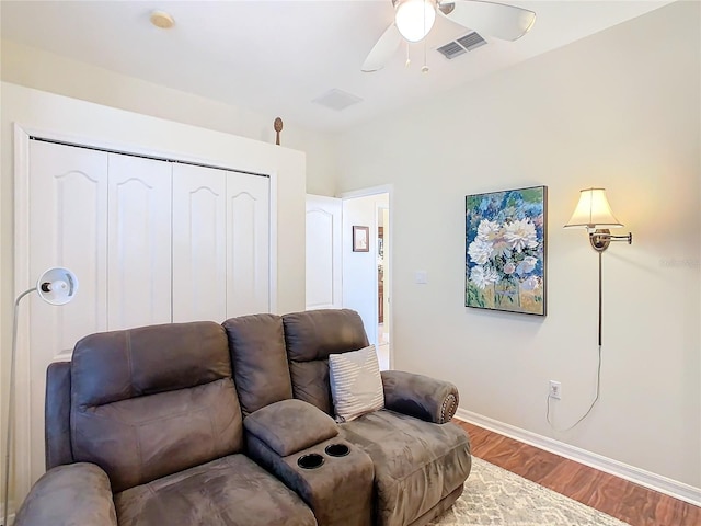 living room featuring ceiling fan and light wood-type flooring