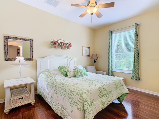 bedroom with ceiling fan and dark hardwood / wood-style flooring