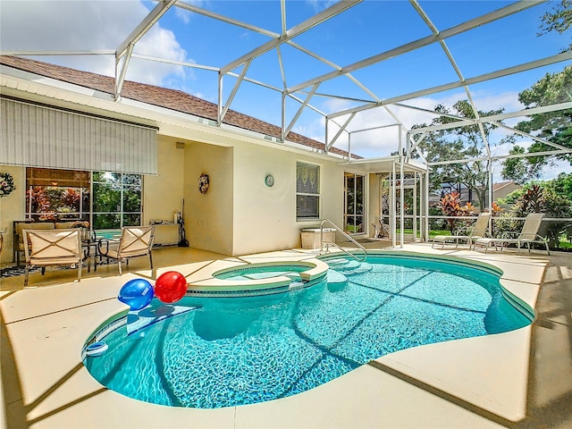 view of pool with a lanai, an in ground hot tub, and a patio