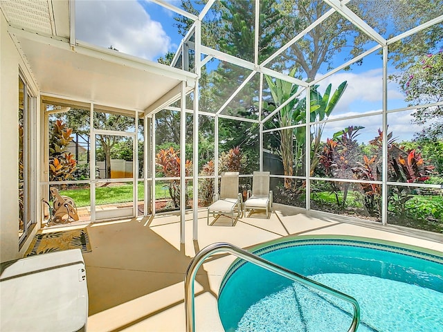 view of swimming pool with a lanai and a patio