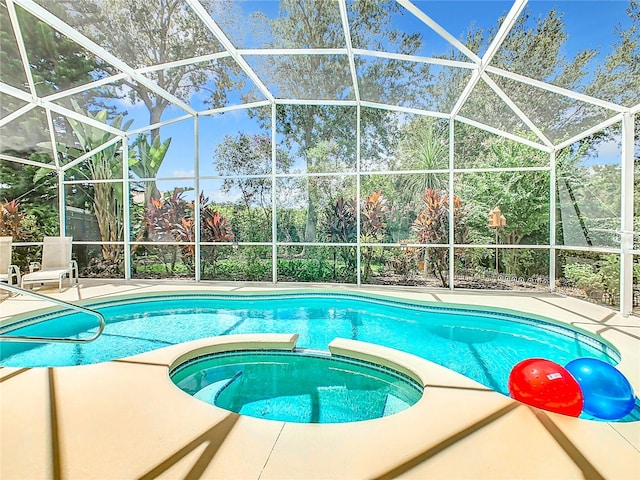 view of pool featuring a patio area and glass enclosure