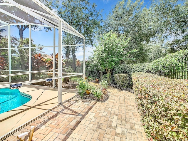 view of patio / terrace featuring a lanai