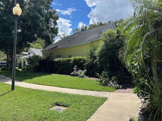 view of home's exterior with a lawn