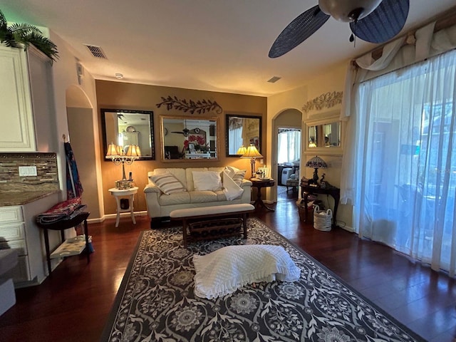 living room with ceiling fan and dark hardwood / wood-style floors