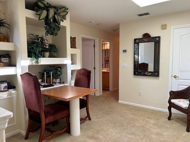 dining room with light carpet