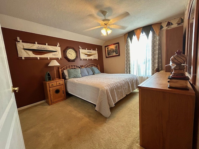 bedroom with carpet flooring, ceiling fan, lofted ceiling, and a textured ceiling