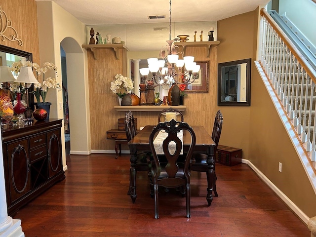 dining area featuring an inviting chandelier and dark hardwood / wood-style flooring