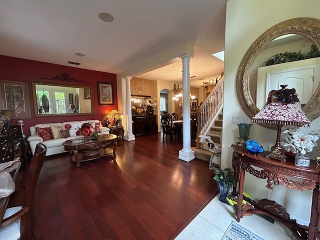 interior space with hardwood / wood-style flooring, ornate columns, and a chandelier