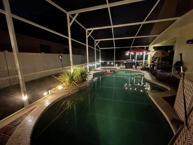 view of pool at twilight