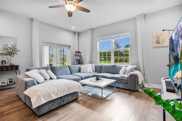 living room with french doors, hardwood / wood-style flooring, and ceiling fan