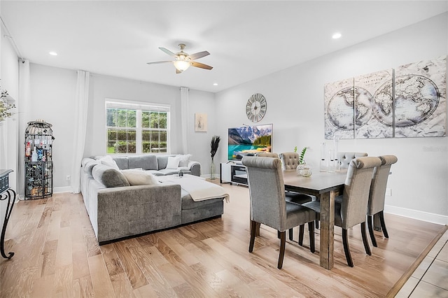 dining area with ceiling fan and light hardwood / wood-style floors