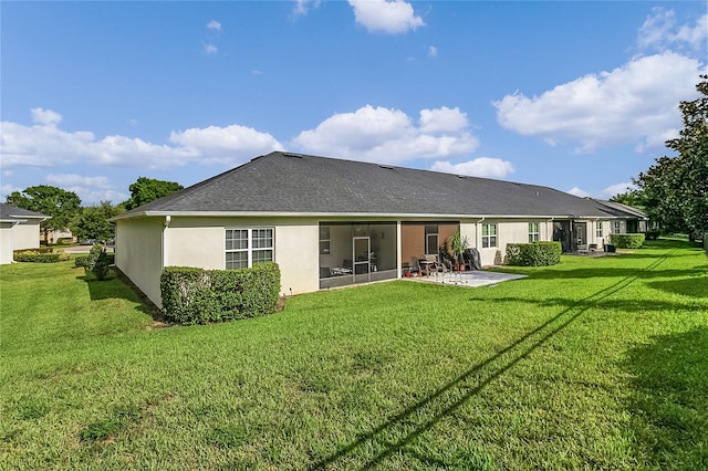 rear view of house featuring a yard and a patio area